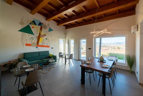 a living room with a green couch and a table at VILLA PORRELLI rooms & spa suite in San Demetrio neʼ Vestini