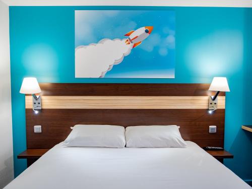a bedroom with a bed with a painting on the wall at Contact Hotel Restaurant La Chaumière entre Orgeval et Flins A13 sortie 8 in Les Mureaux