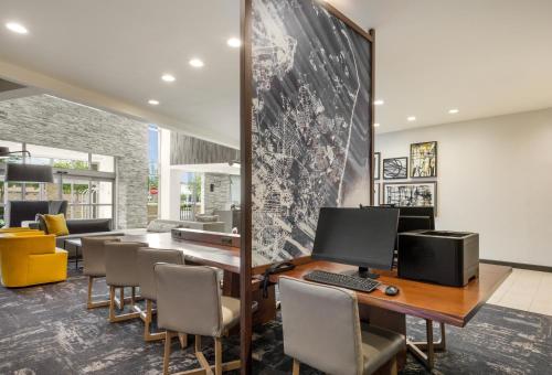 an office with a desk with a computer and chairs at Hyatt Place Hampton Convention Center in Hampton