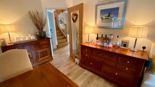 a room with a dresser and a mirror at Keepers Lodge in Swithland