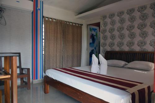 una camera con un grande letto e una finestra di Royal Sundarban Wild Resort a Jharkhali