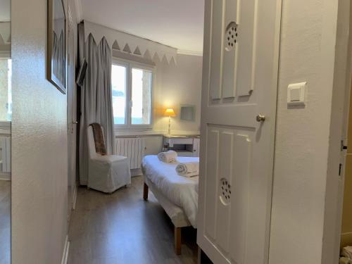a small room with a bed and a window at Hôtel Causse Comtal Rodez, The Originals Relais in Gages-le-Haut