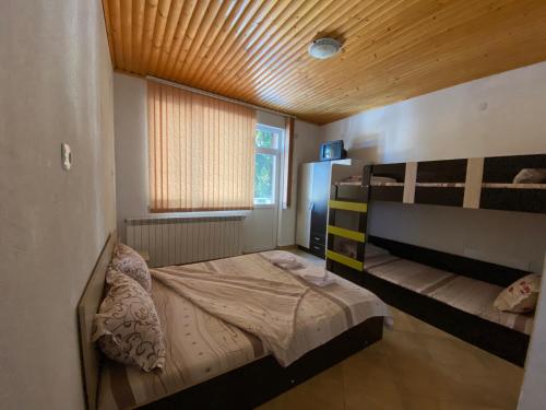 a bedroom with a bunk bed and a window at Вили Сара in Orlino