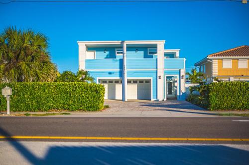 a blue and white building on the side of a street at NEW LISTING! Luxury Beachfront Home - DIRECT Beach Access in Cocoa Beach