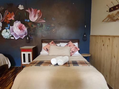 a bedroom with a bed with towels on it at Niños Hotel Fierro in Cusco