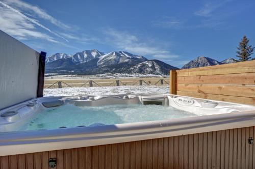 a jacuzzi tub with a view of mountains at Buena Vista Mountain Retreat - Ultimate Privacy with Spa & Unbeatable Views in Buena Vista
