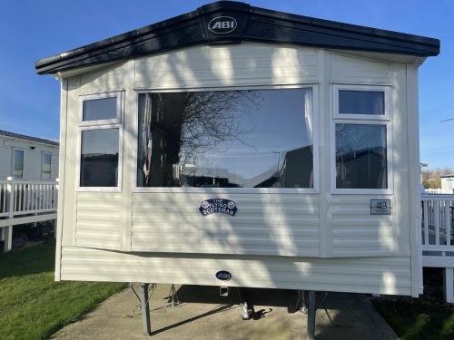 a tiny house is on display in a yard at Excellent caravan 4 birth sleeps 6 Tranquil site in East Mersea