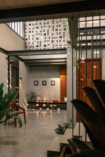 a lobby of a building with tables and chairs at Tamni in Bangkok