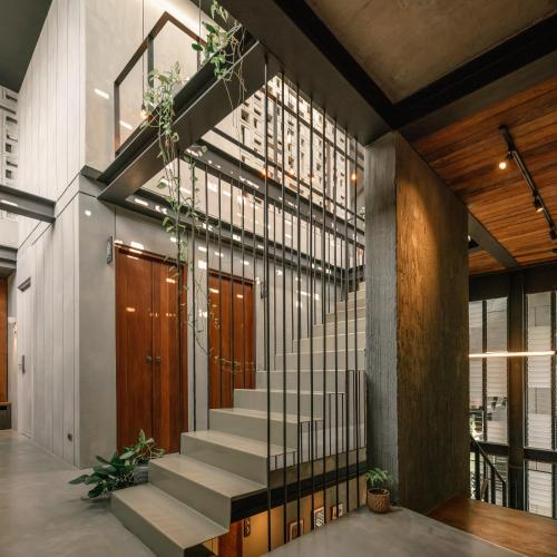 a staircase in a building with a stair case at Tamni in Bangkok