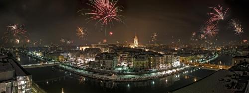 a view of a city with fireworks at night at BoRa Apartments in Villach