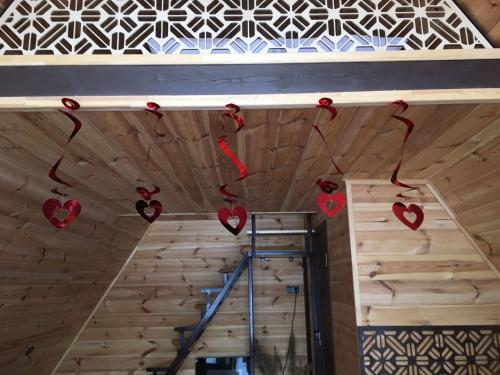 a room with hearts hanging on the ceiling at Aleksandra Viesu Namiņš in Aglona