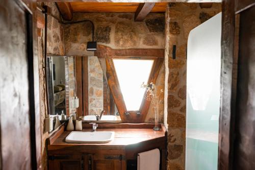 a bathroom with a sink and a mirror at Gardenia in San Javier