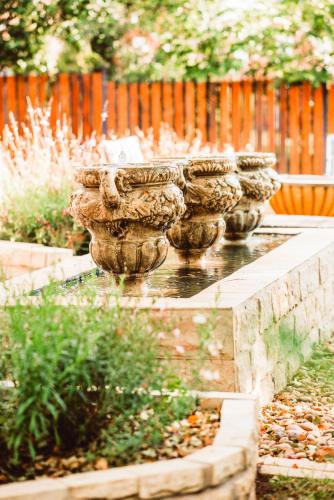a row of stone urns in a garden at Le Grant Guesthhouse in Kroonstad