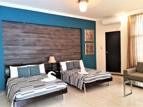 Postel nebo postele na pokoji v ubytování Alameda Cariari Boutique Hotel