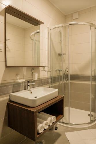 a bathroom with a sink and a shower at Industrial Belišće in Belišće