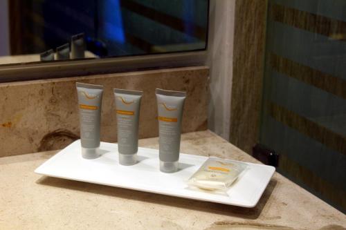 three cups on a white plate on a counter at Real Inn Cancún in Cancún