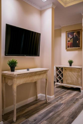 a flat screen tv on a wall in a room at Legacy Boutique Hotel in Korçë