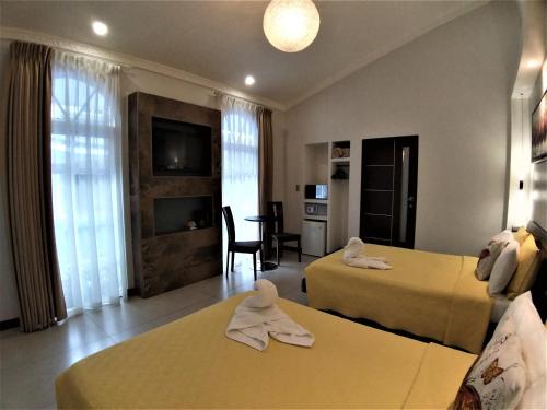 Postel nebo postele na pokoji v ubytování Alameda Cariari Boutique Hotel