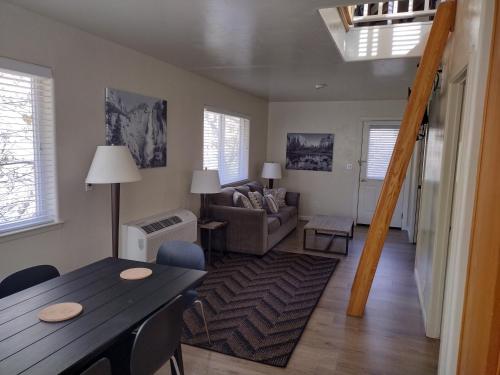 a living room with a table and a couch at Yosemite Gatekeeper's Lodge in El Portal