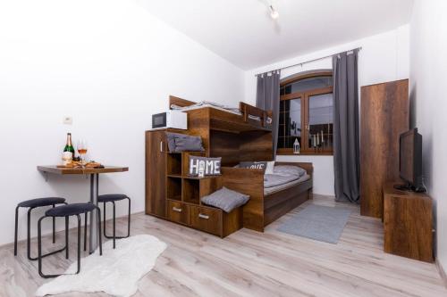 a small room with a bunk bed and a table at Apartment House Kamzík 9 in Donovaly