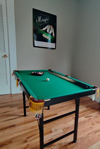 a green pool table with a ball on it at At Home in Oak Park in Oak Park