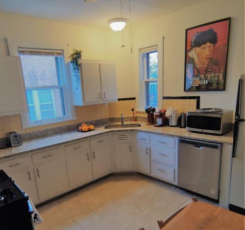 a kitchen with a sink and a microwave at At Home in Oak Park in Oak Park