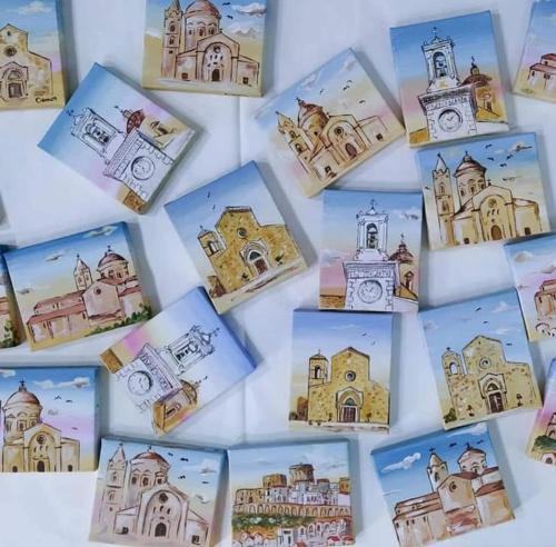 a collage of drawings of buildings on a wall at La lammia di Pisticci in Pisticci