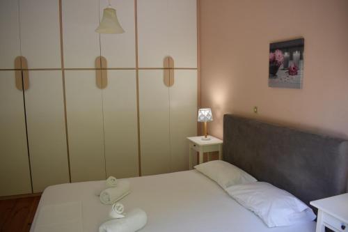 a small bedroom with a bed with white sheets at Bellevue Apartments in Sitia