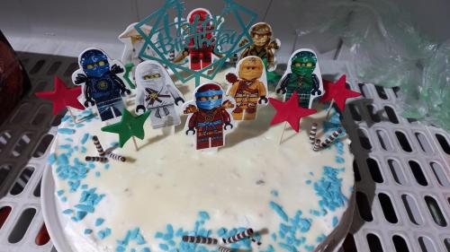 a birthday cake with lego figures on top of it at Hotel Dream in Stara Zagora