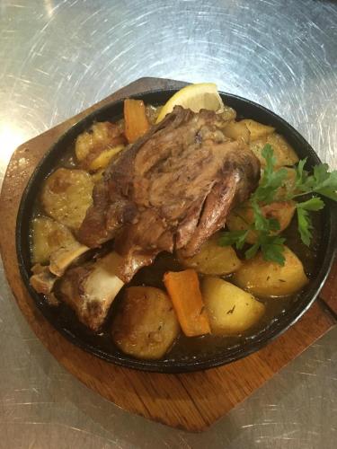 a plate of food with meat and vegetables at Hotel Dream in Stara Zagora