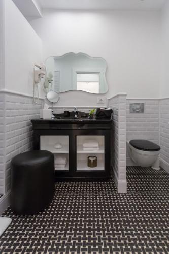 a bathroom with a sink and a toilet and a mirror at Hotel President in Viareggio