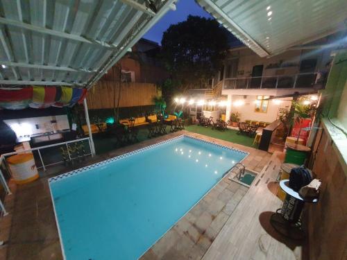 an indoor swimming pool at night with aperature at Maraca Hostel in Rio de Janeiro