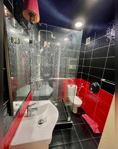 a bathroom with a sink and a shower and a toilet at A lovely apartment with a nice view in Casablanca