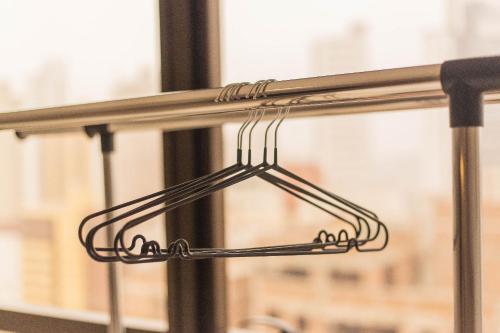 a metal rack in front of a window at Manaíra Apart Hotel por Carpediem in Tambaú