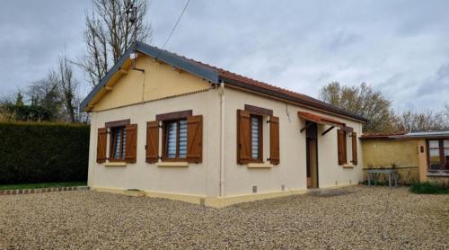 a small white house with brown shuttered windows at Le Dom’Aisne à Zabeth, lieu simple et paisible *** in Chevregny