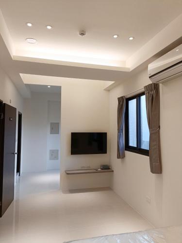 a living room with a flat screen tv on a wall at Penghu Michi Homestay in Hsing-wen