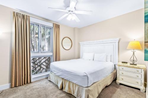 a bedroom with a white bed and a window at Sand & Serenity in Destin