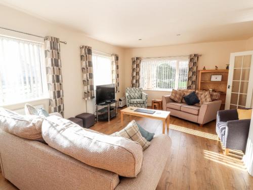 a living room with a couch and a tv at Awel Y Berwyn in Oswestry