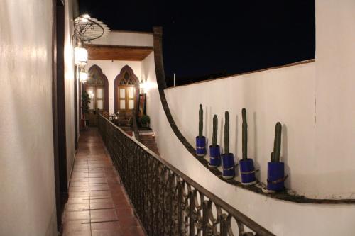 a hallway with a wall with blue vases on it at El Serafin Hotel Boutique in Querétaro