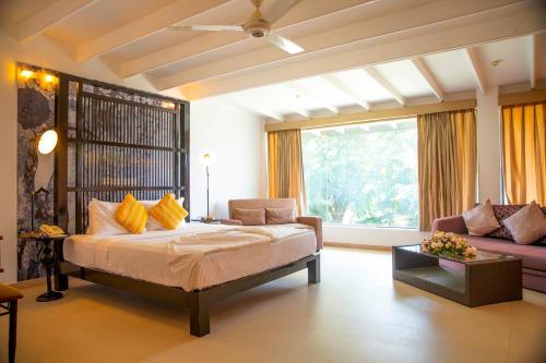 A bed or beds in a room at Thilanka Hotel