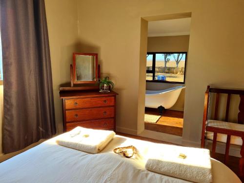 Ένα ή περισσότερα κρεβάτια σε δωμάτιο στο Die Blouhuis Farmhouse Retreat with a hot tub