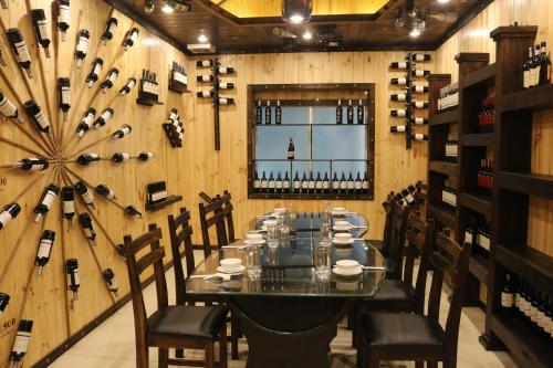 a dining room with a table and chairs and wine bottles at Viet Uc Hotel in Ben Tre