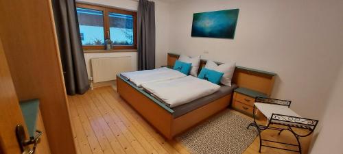 Habitación pequeña con cama y ventana en Ferienwohnung Seeberg mit Almfeeling en Faistenau