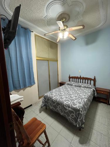 a bedroom with a bed and a ceiling fan at Hotel Paris in San Juan de los Lagos