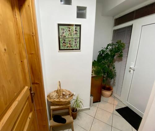 a hallway with plants and a bowl on a stool at Jack's Place in Trbovlje