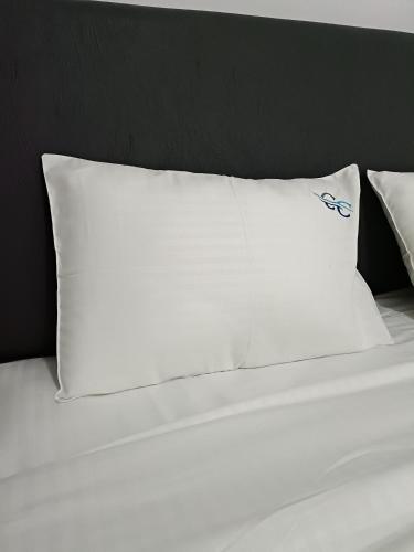 a white pillow sitting on top of a bed at City Centre in Mombasa