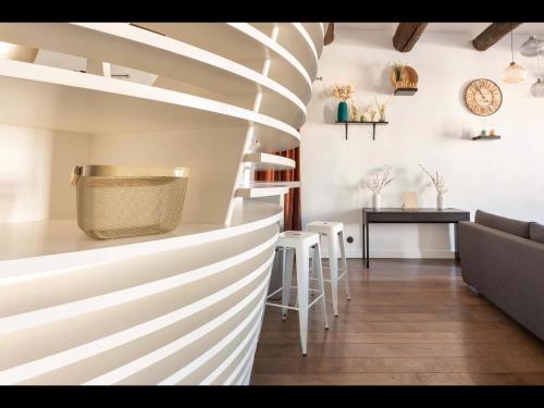 a living room with a spiral staircase and a table at Vieux-Port Magnifique Appartement Loft in Marseille