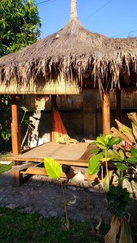 a straw hut with a table in front of it at Pondok Mangga in Mataram