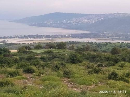 a view of a field and a body of water at Chen Ba'Galil in Kahal