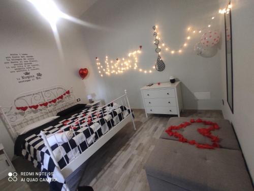 a bedroom with a bed and a dresser and lights at SCACCO MATTO Holiday House in Taranto